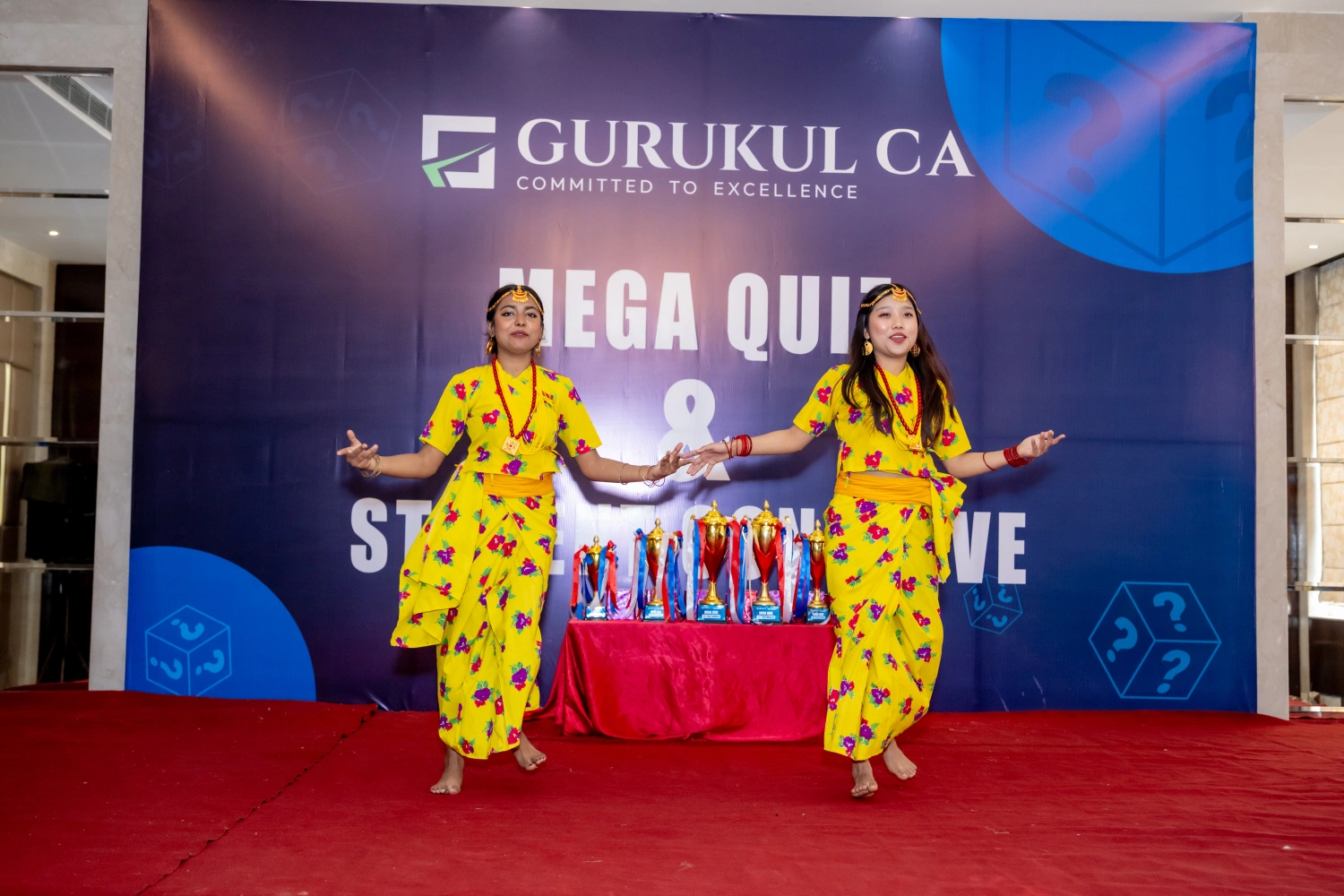 Students performing on stage at Gurukul CA Mega Quiz