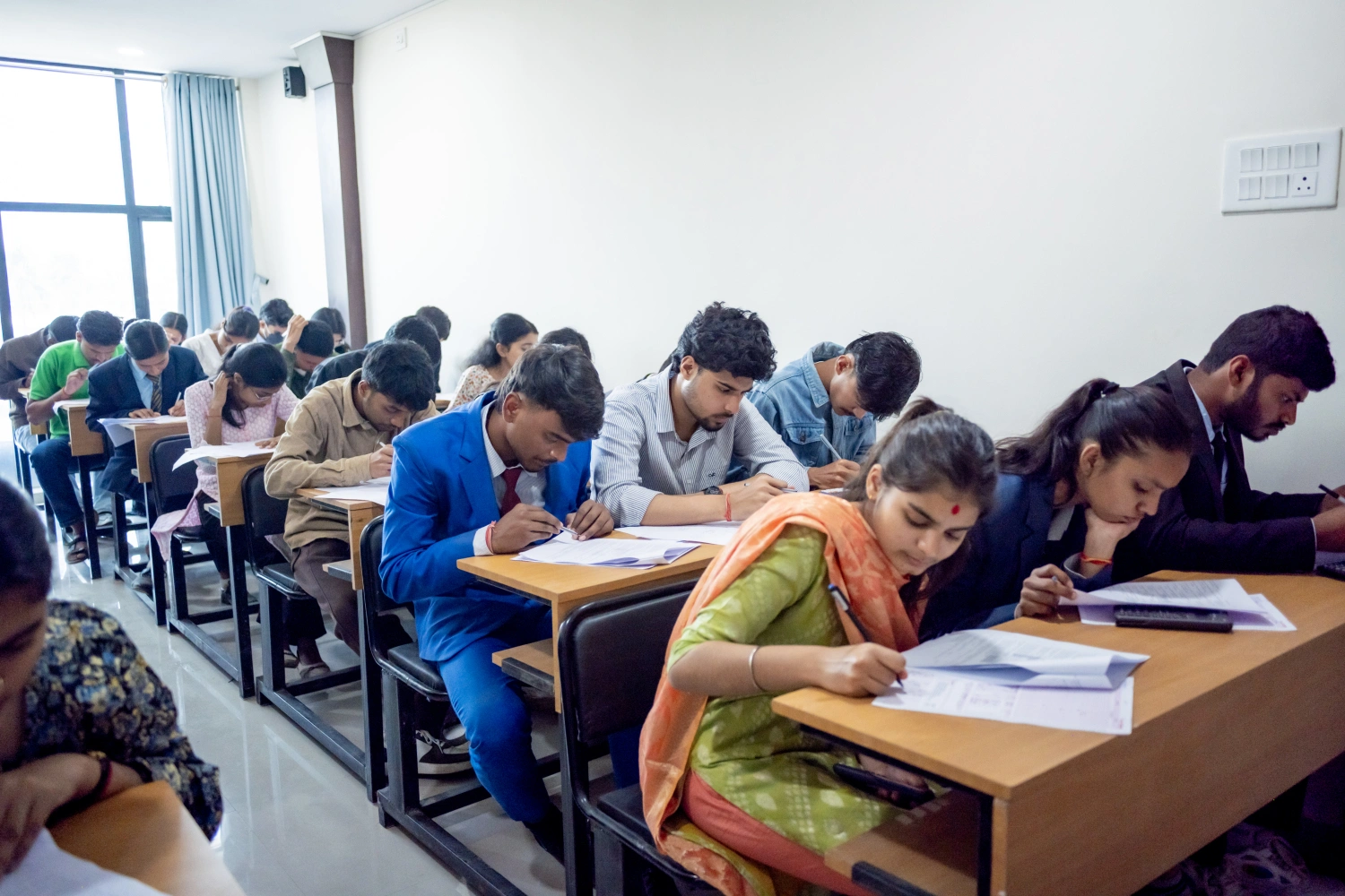 Students attending an examination in a classroom