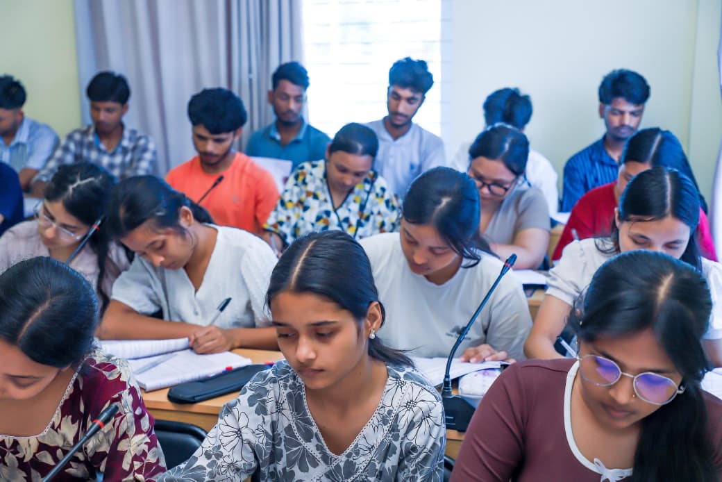 Students writing and studying during a classroom session